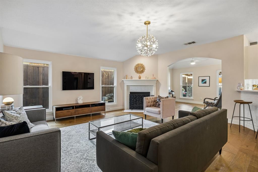 12404 Ark Road Frisco, TX 75035 - Photo 5 of 28 a living room with furniture a flat screen tv and a fireplace