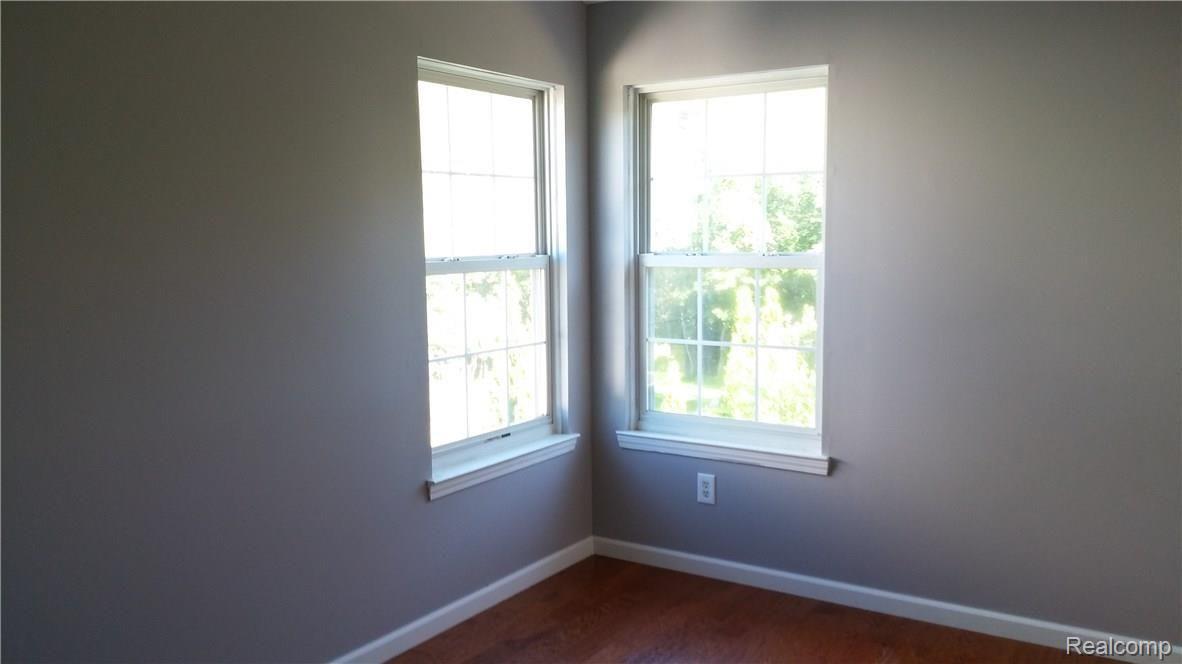 825 3rd Street Fenton, MI 48430 - Photo 19 of 26 Bedroom 3 offers double corner windows for lots of light.