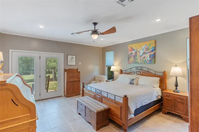 a bedroom with a large bed and a chandelier