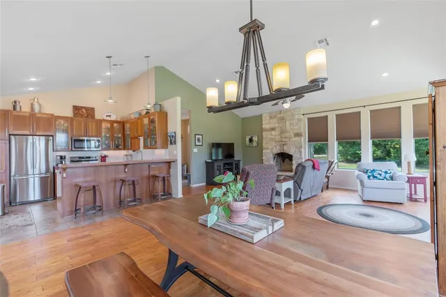 a living room with furniture a fireplace and a chandelier