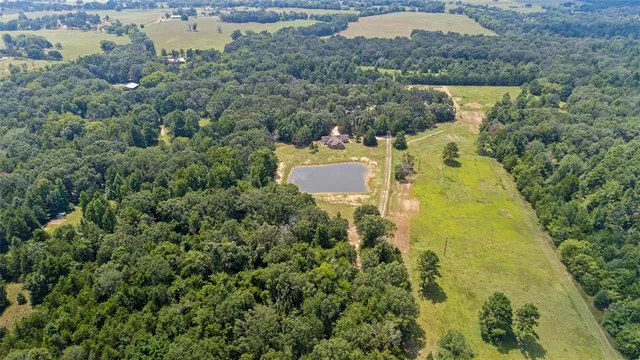 an aerial view of residential houses with outdoor space and swimming pool
