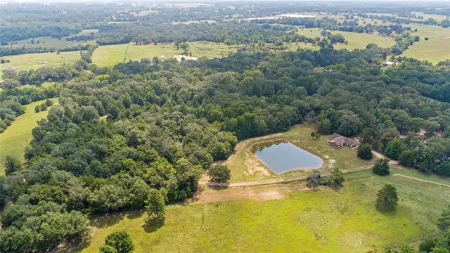 an aerial view of residential houses with outdoor space and swimming pool
