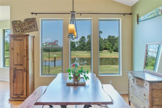 a view of a dining room with a table and chairs