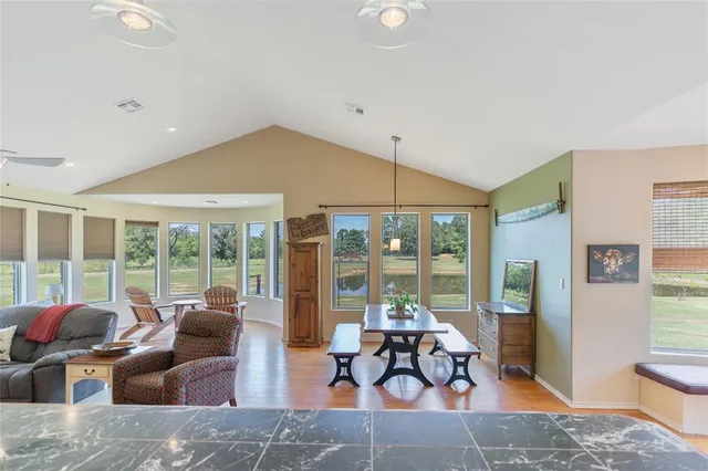 a living room with furniture and floor to ceiling windows