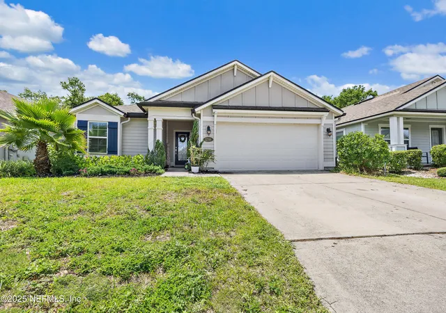 a front view of house with yard and trees around
