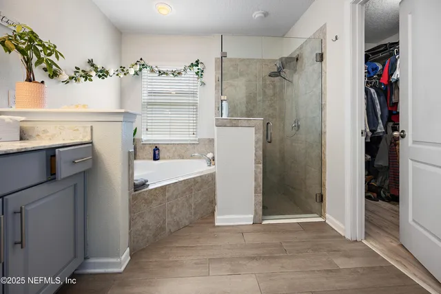a bathroom with a tub sink and a shower