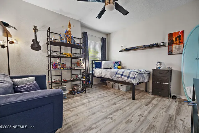 a living room with furniture a rug and a wooden floor