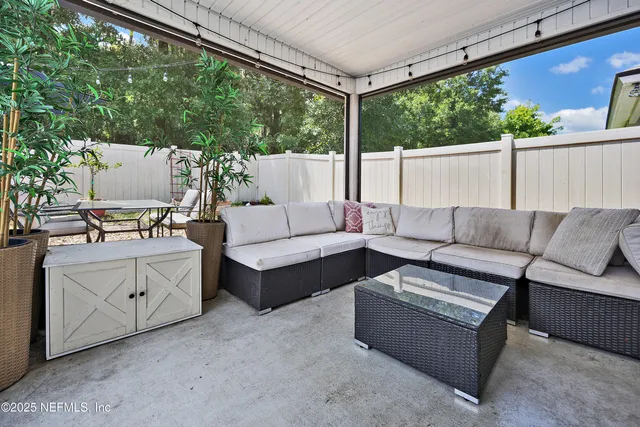 a roof deck with couches and wooden floor