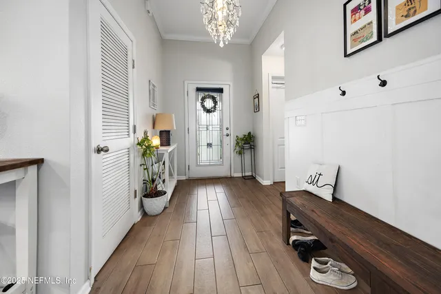 a view of a hallway to a livingroom with furniture