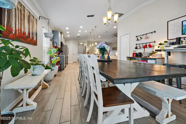 a view of a dining room with furniture and chandelier