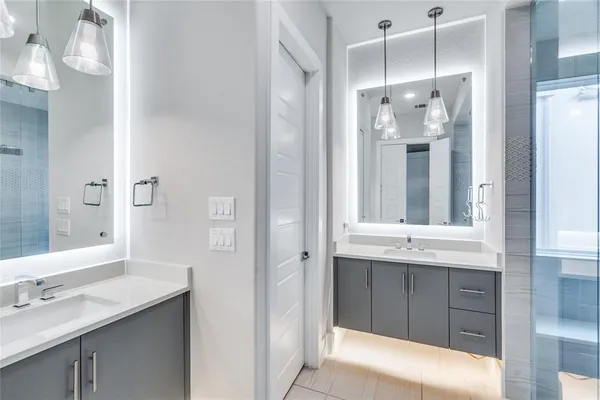 a bathroom with a granite countertop sink mirror and double