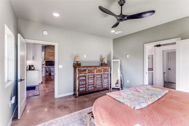 a bedroom with a large bed and a chandelier
