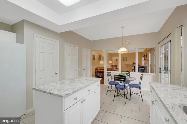 a living room with furniture a fireplace and a large window