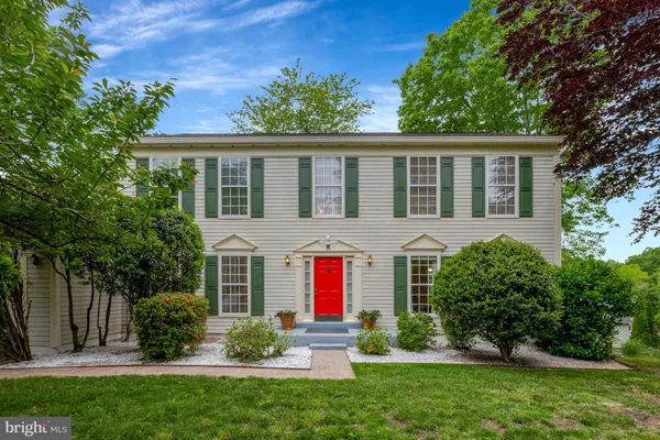 a view of a livingroom with wooden floor and furniture