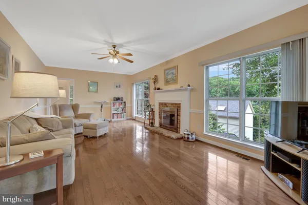 a view of a hallway with windows and chandelier