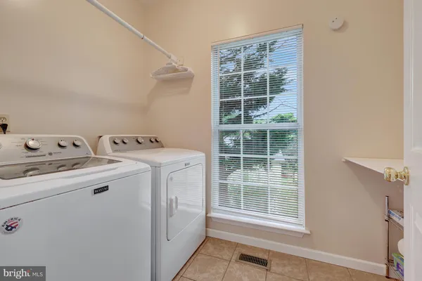 a bathroom with a bathtub shower sink and a mirror