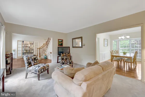 a living room with furniture a large window and a flat screen tv