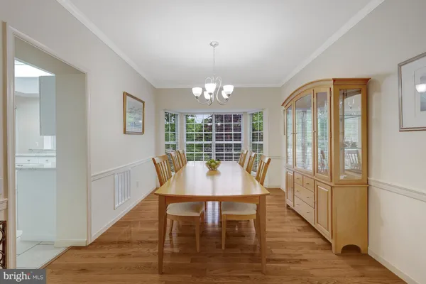 a kitchen with granite countertop white cabinets and a window