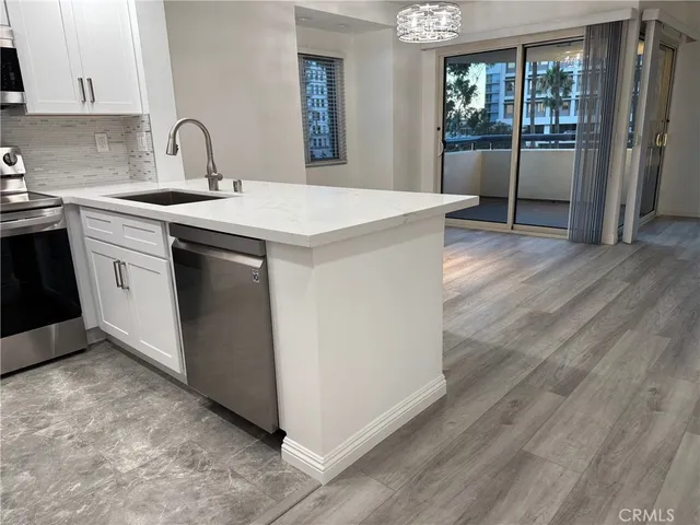 a kitchen with a sink and wooden cabinets