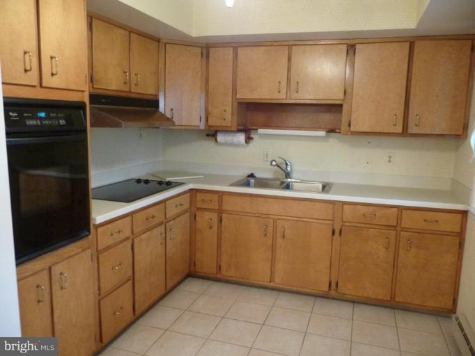 3074 Tudor Hall Road Riva, MD 21140 - Photo 2 of 13 a kitchen with stainless steel appliances granite countertop a sink and cabinets