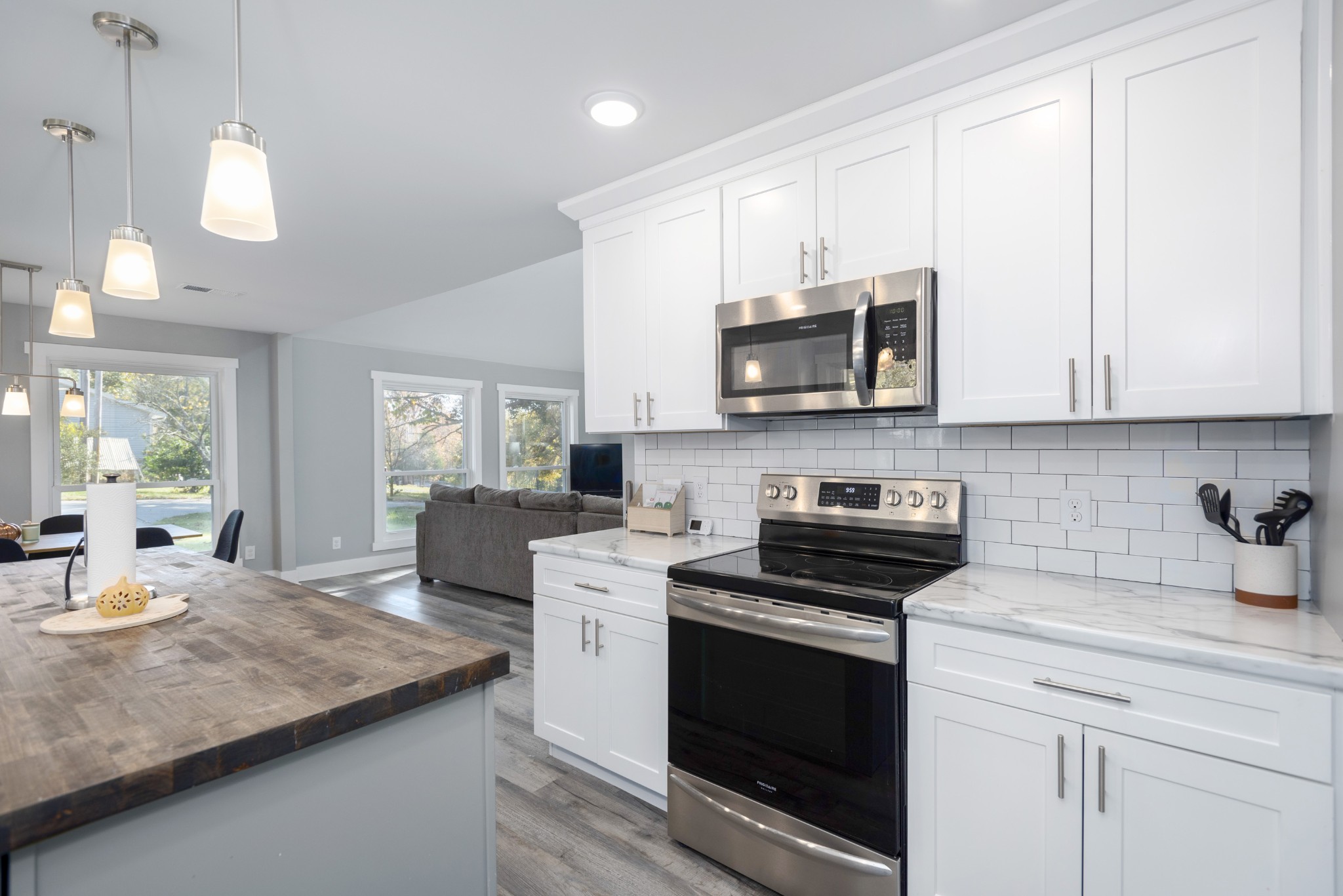 108 Esque Road Bethpage, TN 37022 - Photo 5 of 30 a kitchen with stainless steel appliances granite countertop a sink a stove a microwave and cabinets