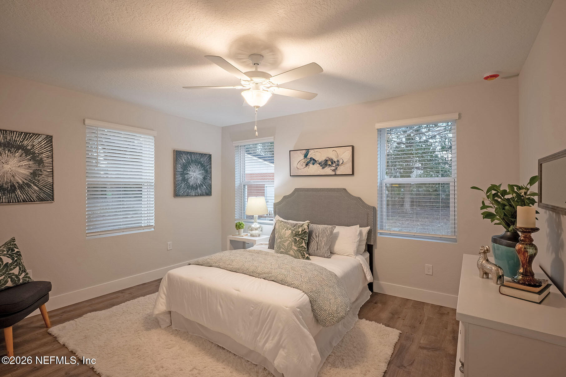 2743 Chelton Road Jacksonville, FL 32216 - Photo 12 of 51 a bedroom with a large bed and a chandelier
