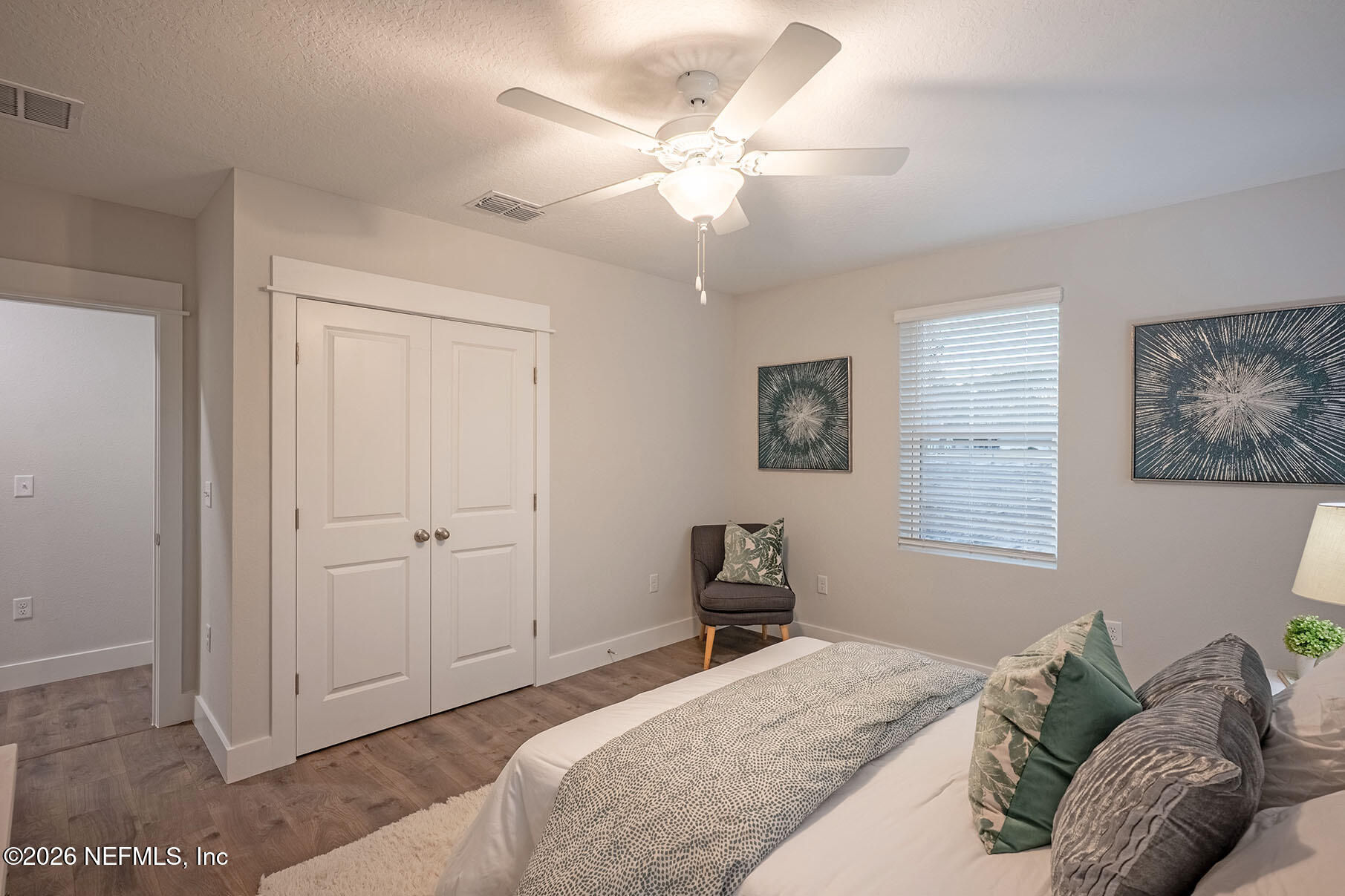2743 Chelton Road Jacksonville, FL 32216 - Photo 13 of 51 a bedroom with a bed and a chandelier