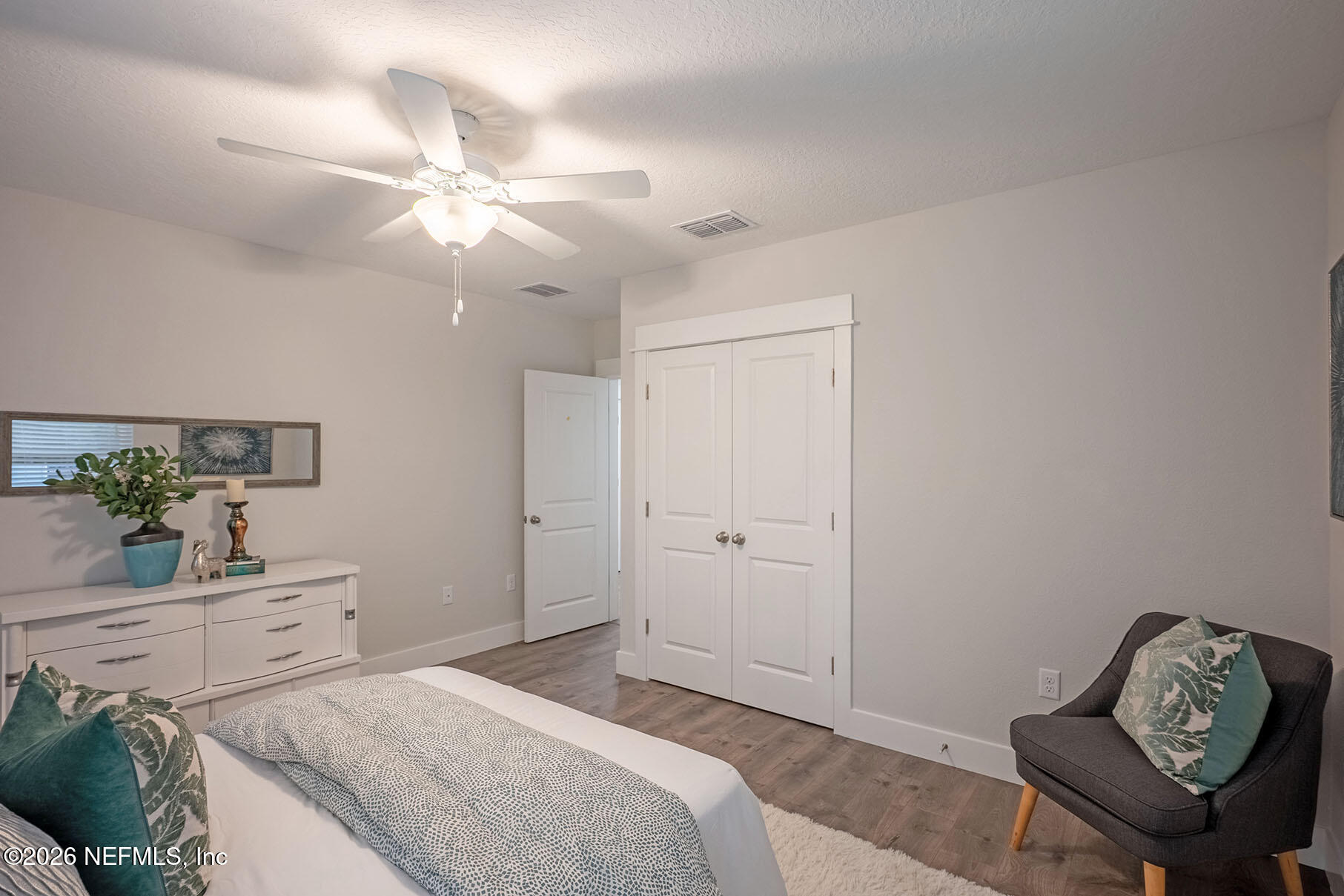 2743 Chelton Road Jacksonville, FL 32216 - Photo 14 of 51 a bedroom with a bed and a chandelier