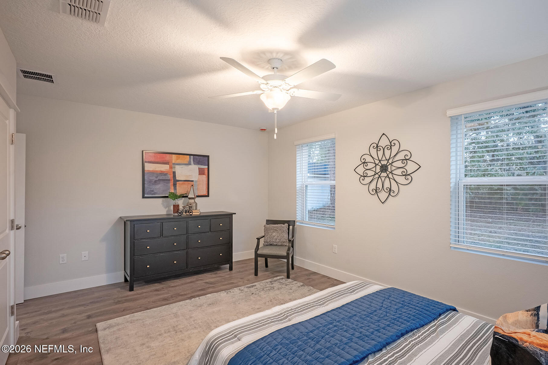 2743 Chelton Road Jacksonville, FL 32216 - Photo 18 of 51 a bedroom with a bed and a desk