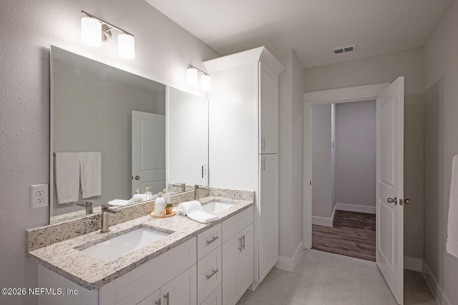 2743 Chelton Road Jacksonville, FL 32216 - Photo 22 of 51 a bathroom with a sink double vanity and a mirror