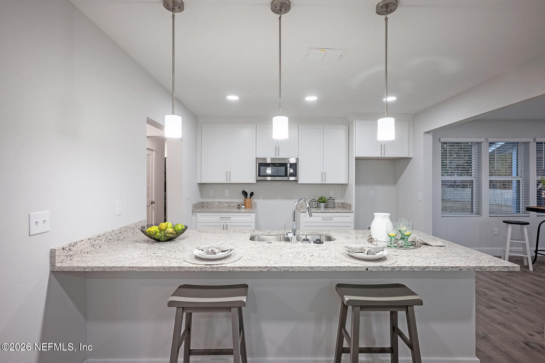 2743 Chelton Road Jacksonville, FL 32216 - Photo 30 of 51 a kitchen with a sink a counter space and cabinets