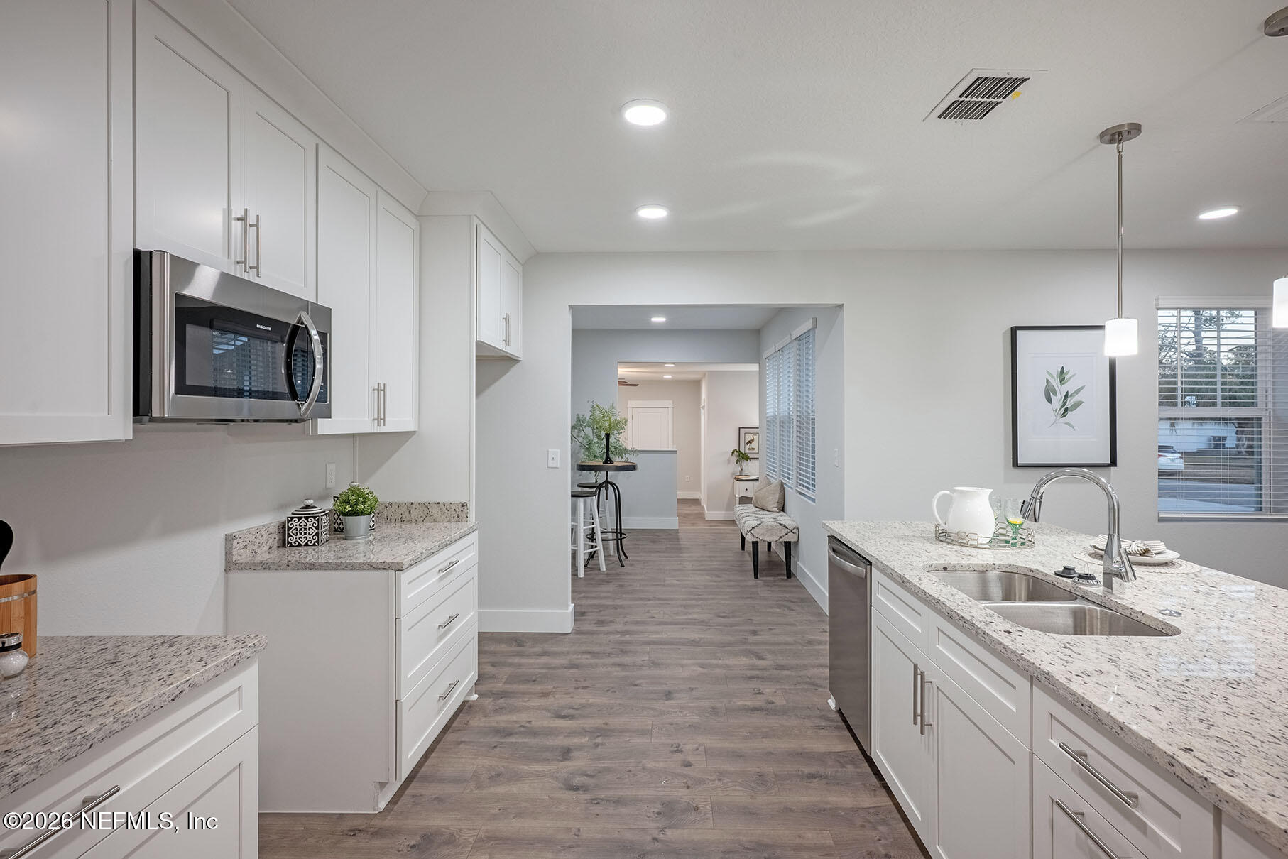 2743 Chelton Road Jacksonville, FL 32216 - Photo 32 of 51 a kitchen with stainless steel appliances granite countertop a sink stove and cabinets
