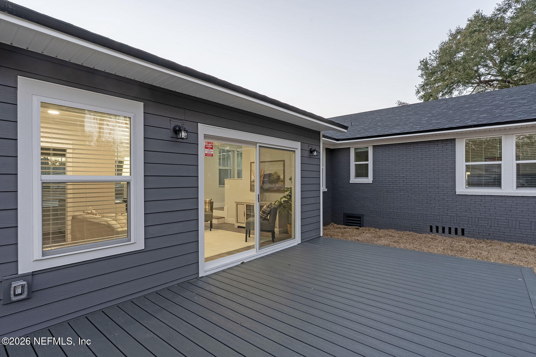 2743 Chelton Road Jacksonville, FL 32216 - Photo 50 of 51 a view of an empty room with wooden floor and a window