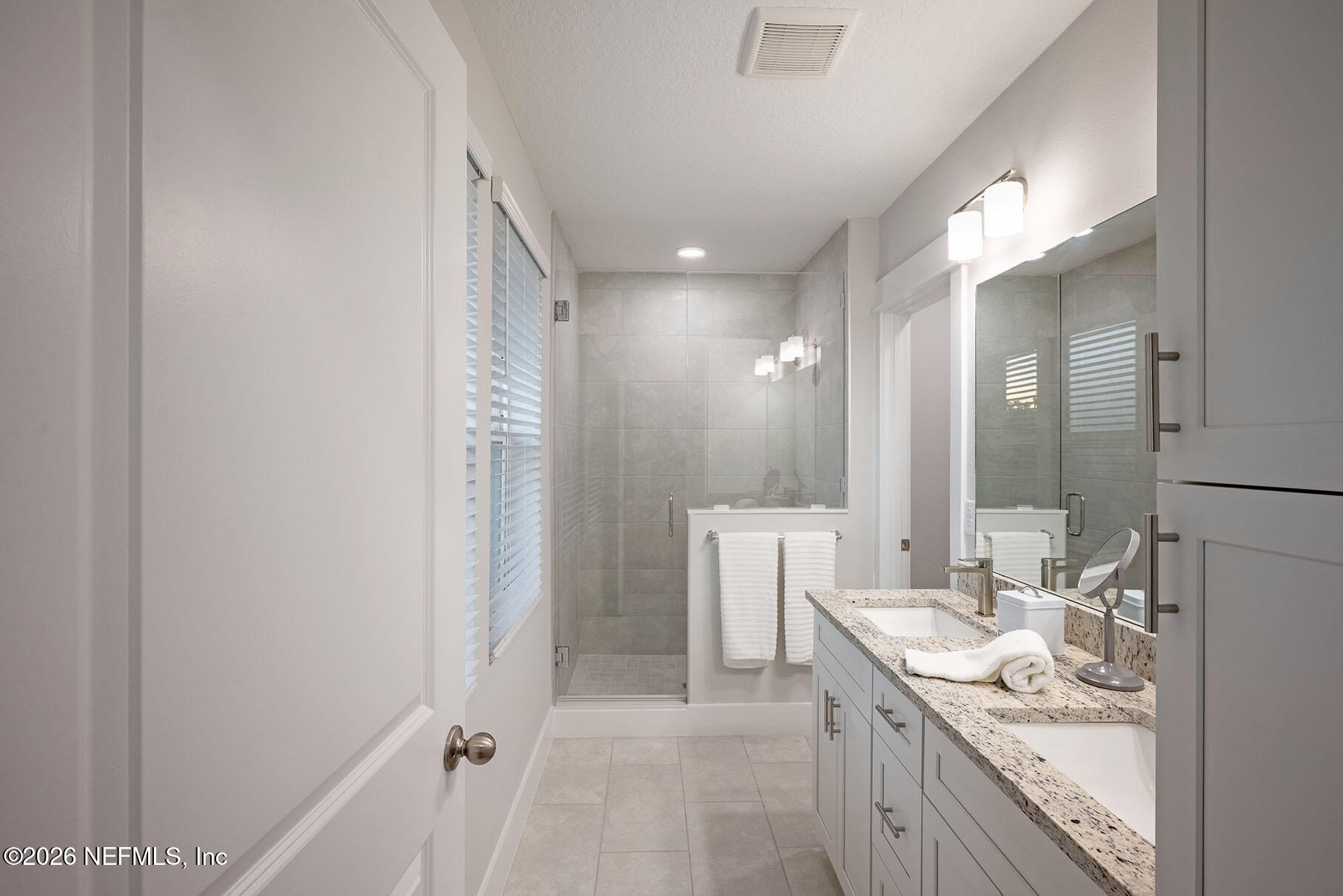 2743 Chelton Road Jacksonville, FL 32216 - Photo 8 of 51 a bathroom with a granite countertop sink and a mirror