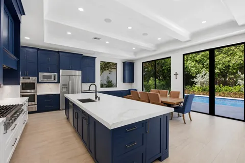 a large kitchen with kitchen island a large island in it