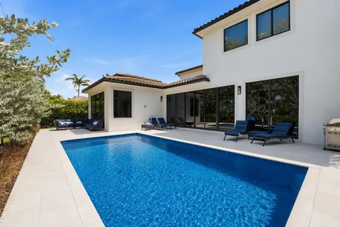 a view of house with swimming pool and furniture