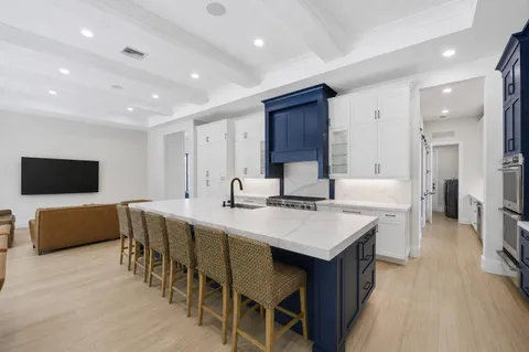 a kitchen with refrigerator and cabinets