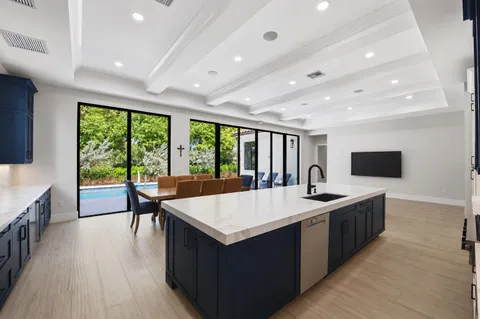 a large kitchen with a table and chairs