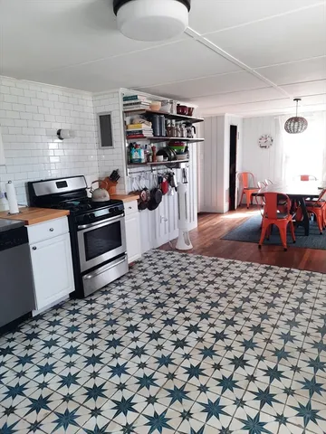 a kitchen with stainless steel appliances a stove a sink and a refrigerator
