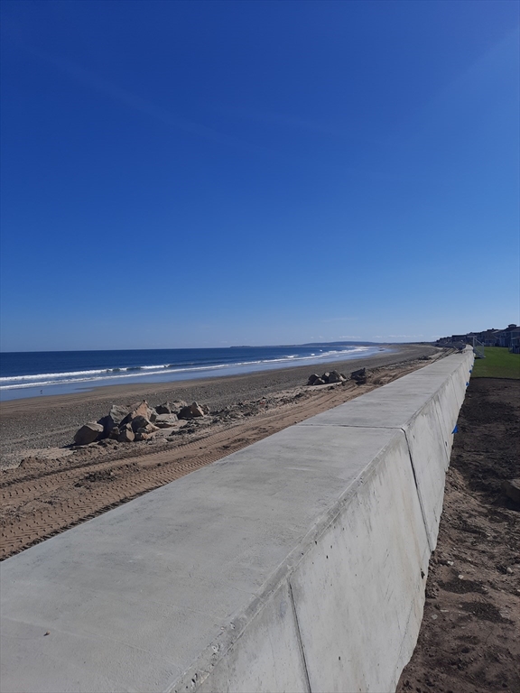 77 Gurnet Road, Unit 77 Duxbury, MA 02332 - Photo 8 of 15 a close up of a fireplace with wooden floor