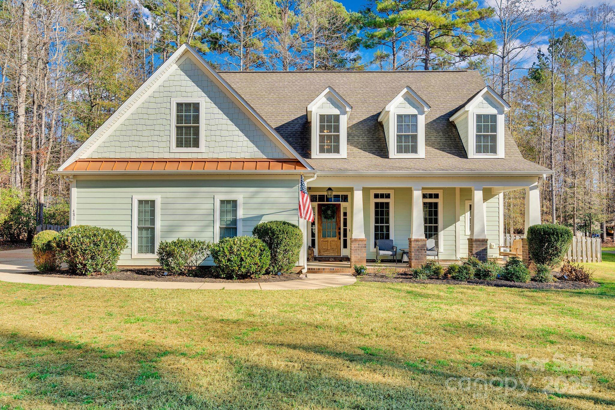 a front view of a house with swimming pool and porch