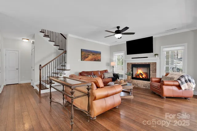 a living room with furniture a flat screen tv and a fireplace