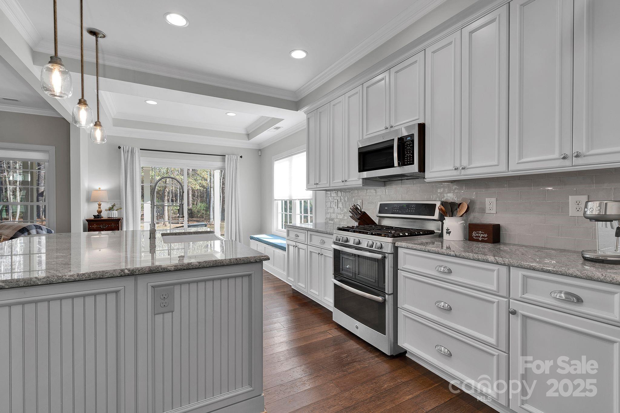 481 Evergreen Road Lake Wylie, SC 29710 - Photo 19 of 45 a kitchen with stainless steel appliances granite countertop a stove a sink and white cabinets