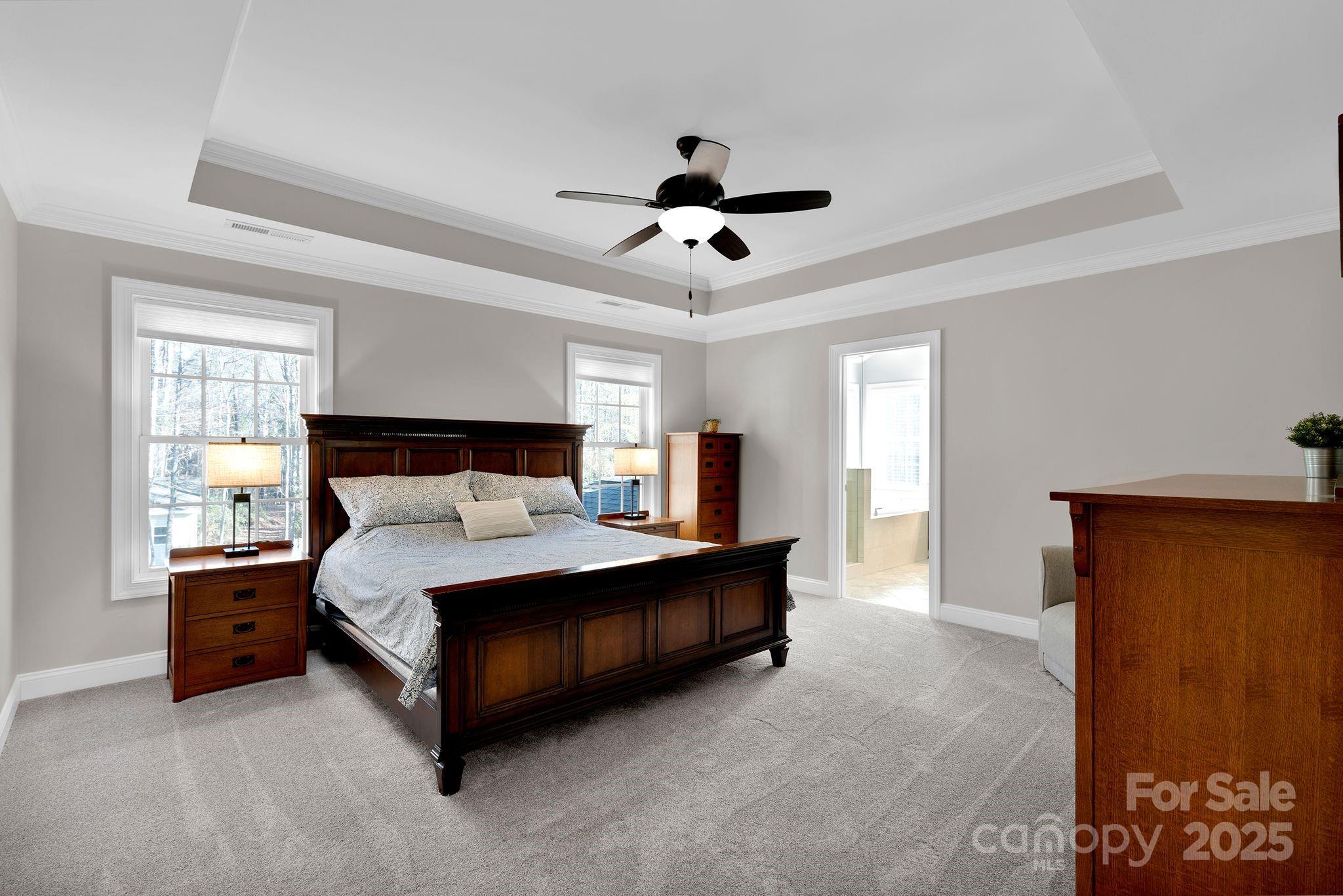 481 Evergreen Road Lake Wylie, SC 29710 - Photo 23 of 45 a spacious bedroom with a bed and a chandelier