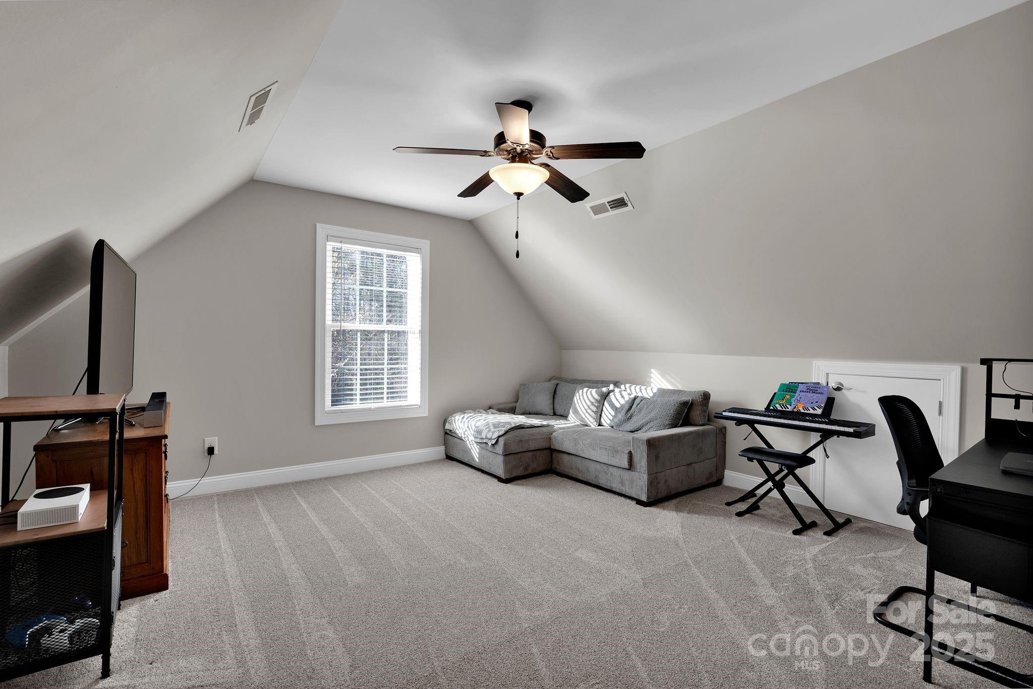 481 Evergreen Road Lake Wylie, SC 29710 - Photo 28 of 45 a living room with furniture a flat screen tv and a window