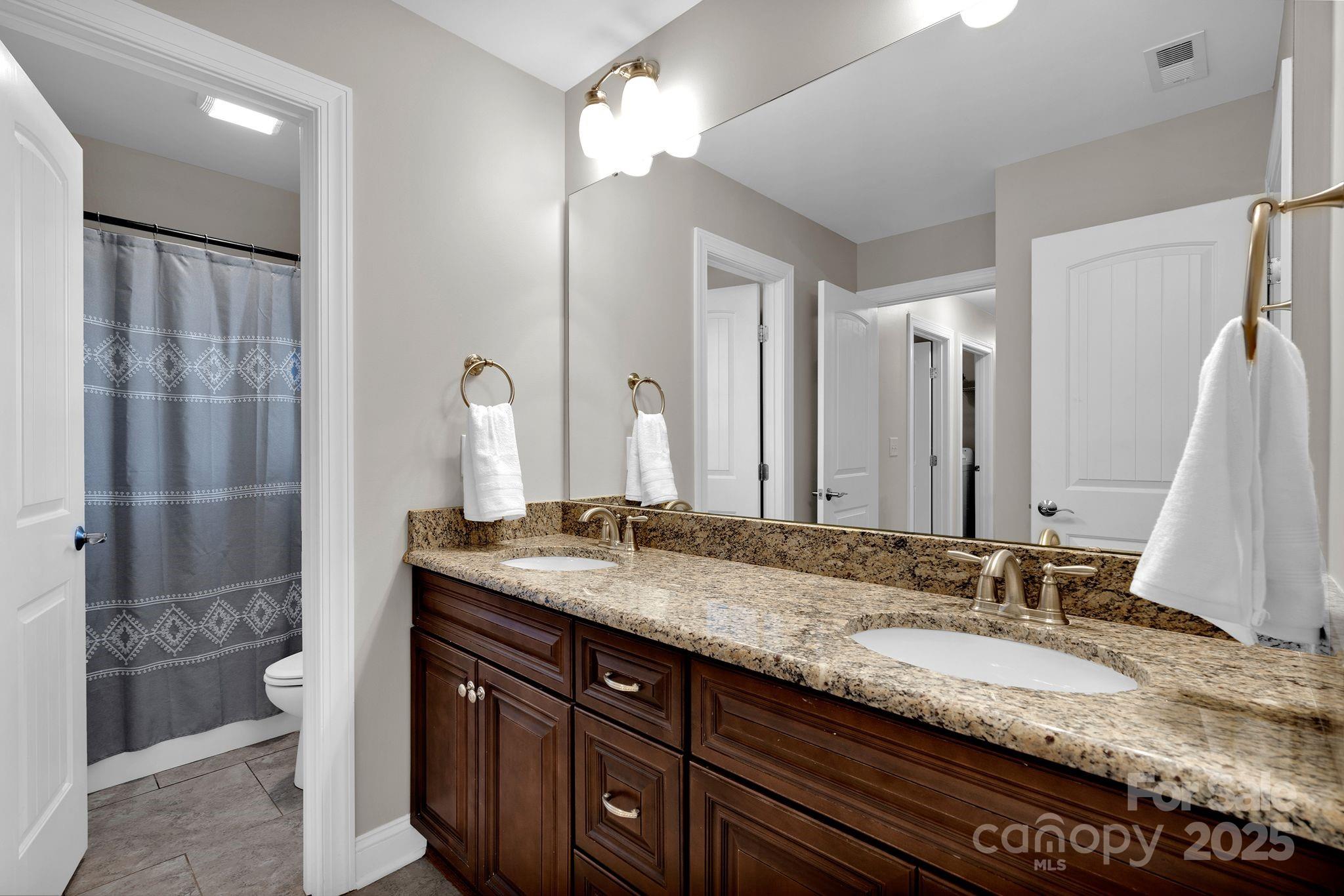 481 Evergreen Road Lake Wylie, SC 29710 - Photo 31 of 45 a bathroom with a granite countertop double vanity sink and a mirror