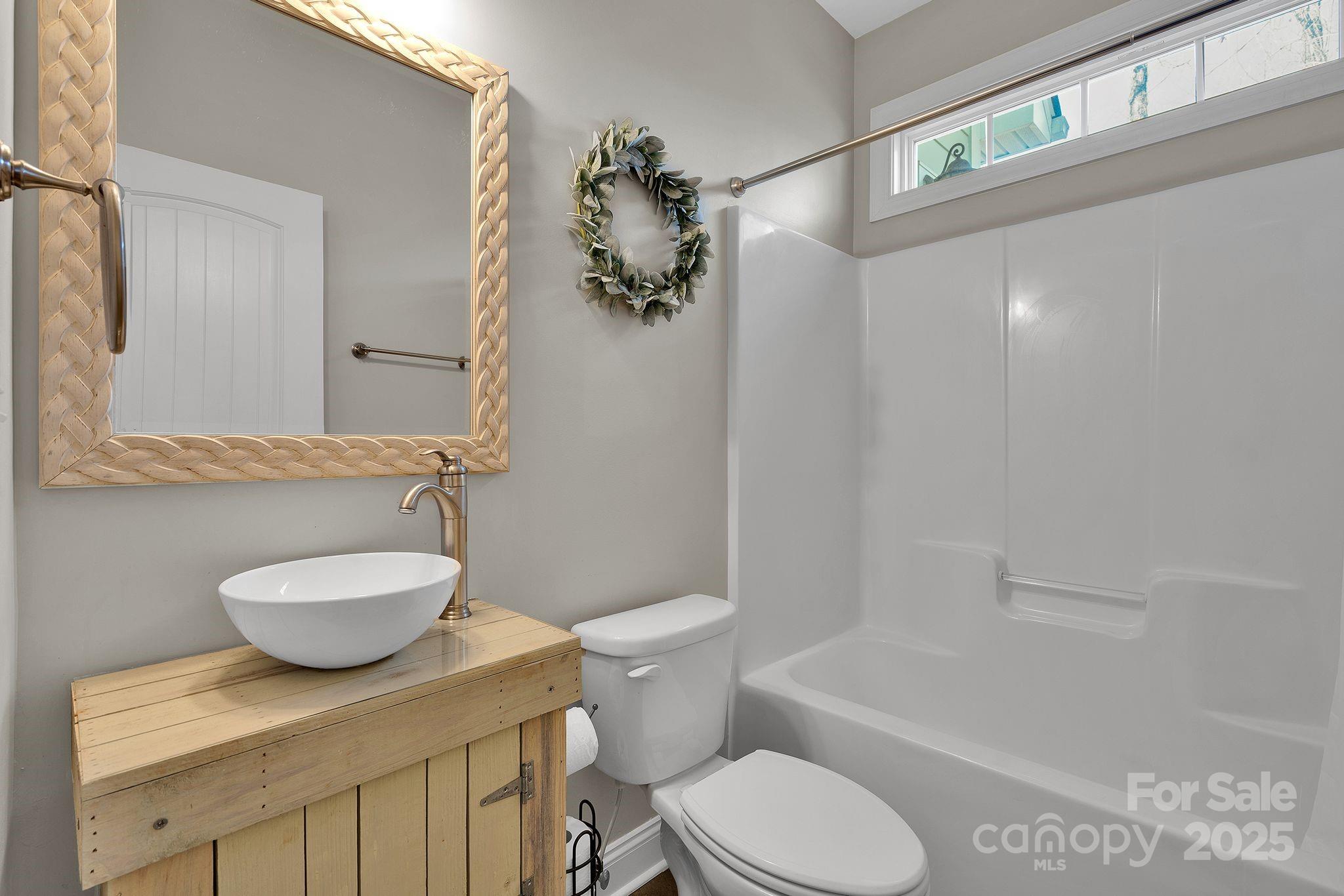 481 Evergreen Road Lake Wylie, SC 29710 - Photo 42 of 45 a bathroom with a granite countertop toilet sink and mirror