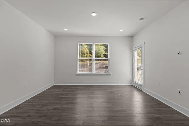 a kitchen with stainless steel appliances granite countertop a sink a stove and a wooden floors