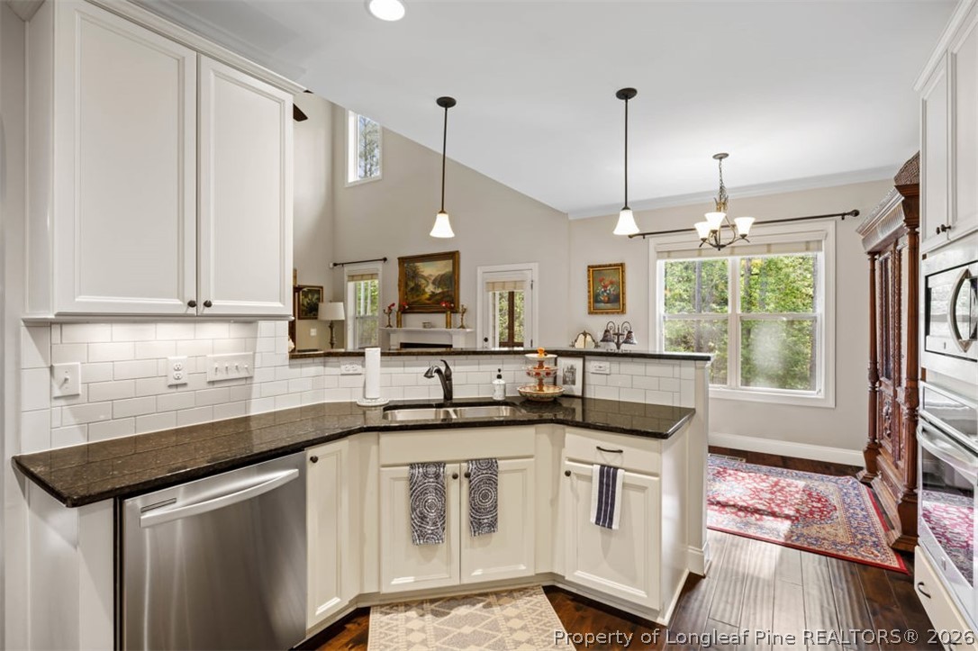 48 Valley Brook Lane Spring Lake, NC 28390 - Photo 14 of 50 a kitchen that has a sink a stove and cabinets