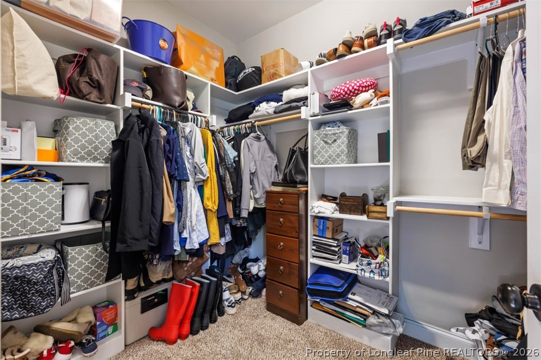 48 Valley Brook Lane Spring Lake, NC 28390 - Photo 19 of 50 a view of walk in closet with clothes and shoes